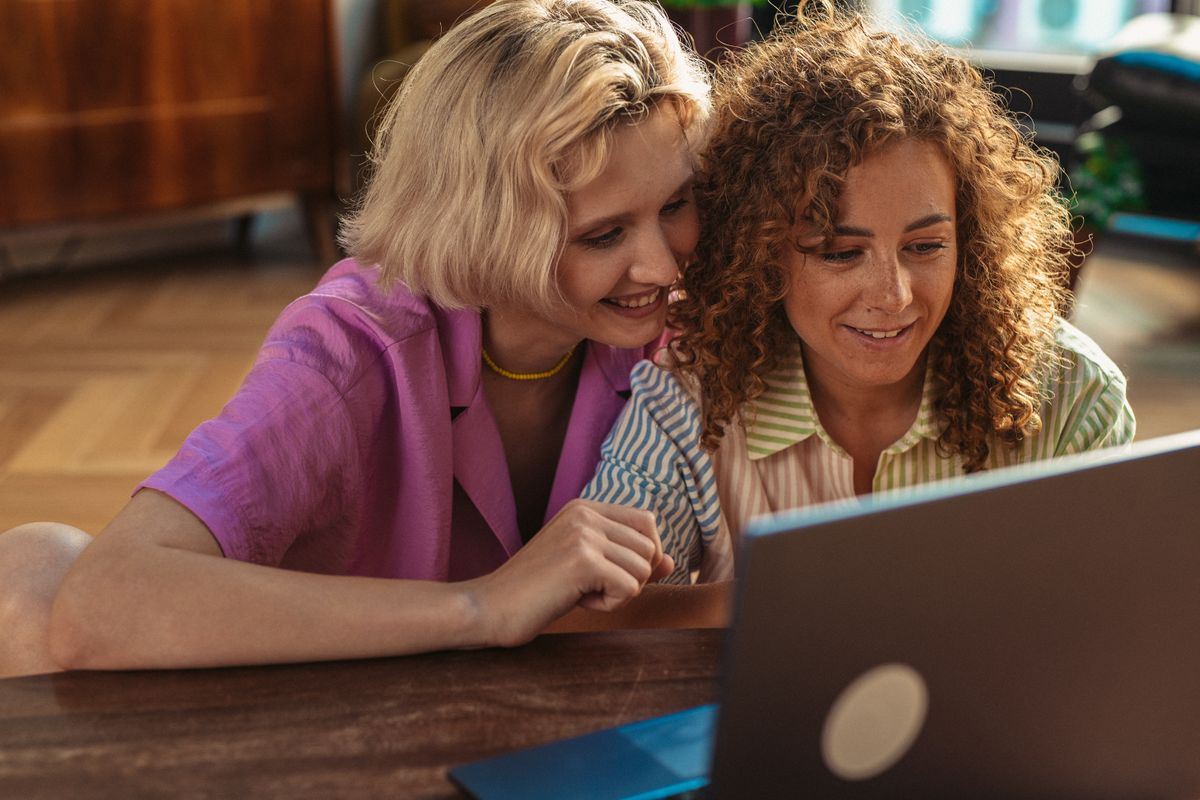 Two women working together at a laptop